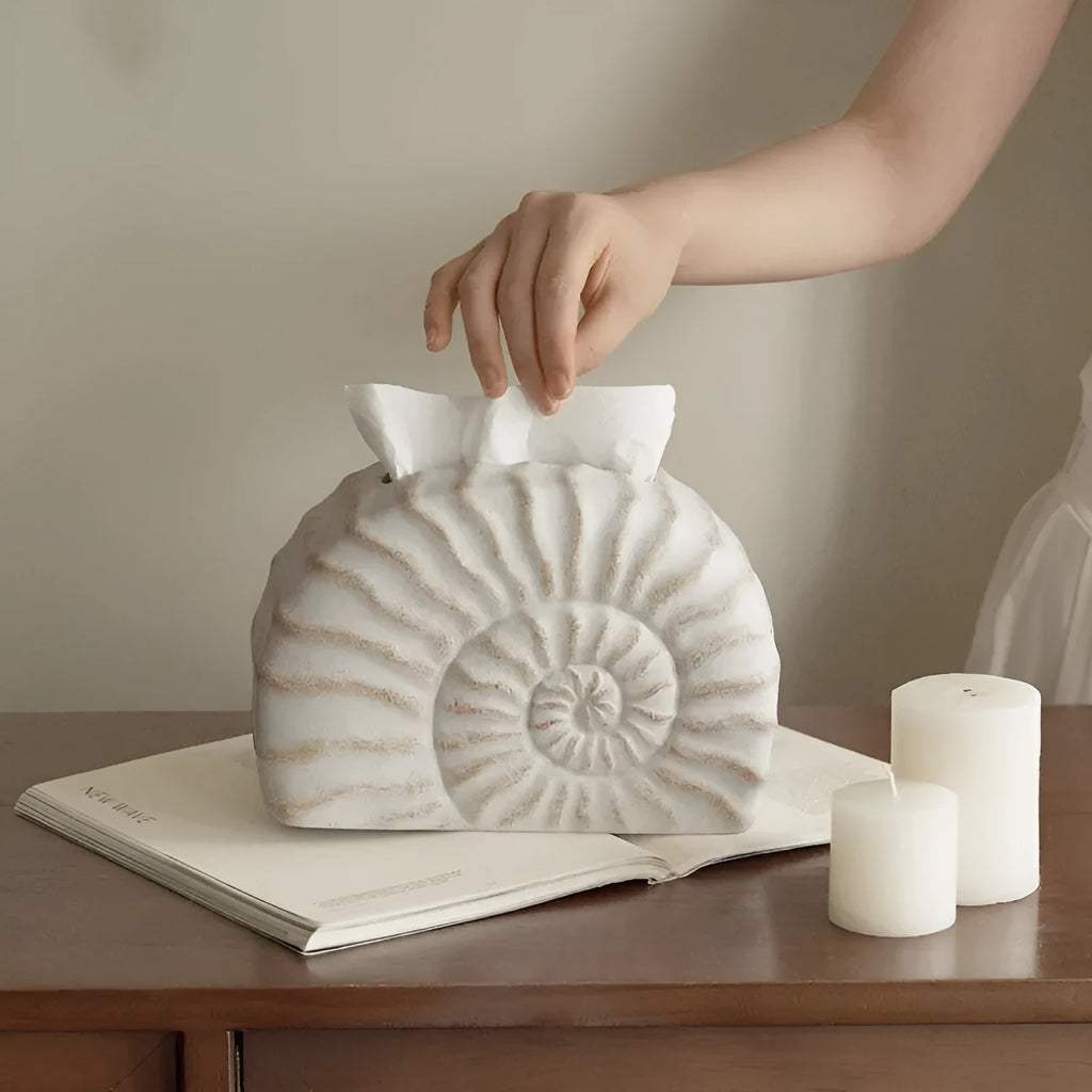 Modern conch shell shaped resin tissue box cover in a conch ramble colour.