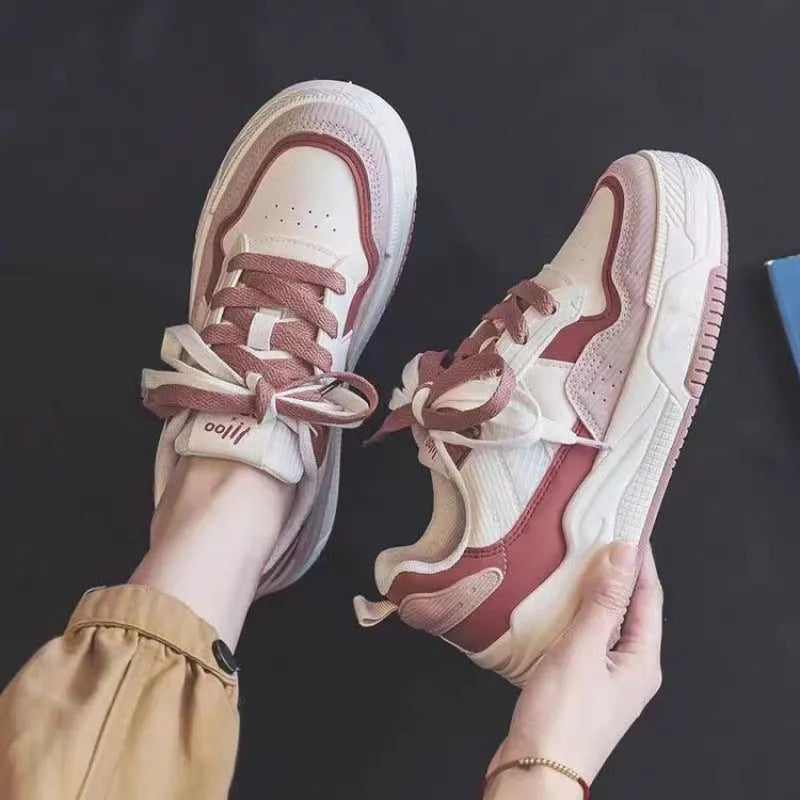 Women's pink low-top sneakers with imitation leather upper and rubber sole for hidden height increase.