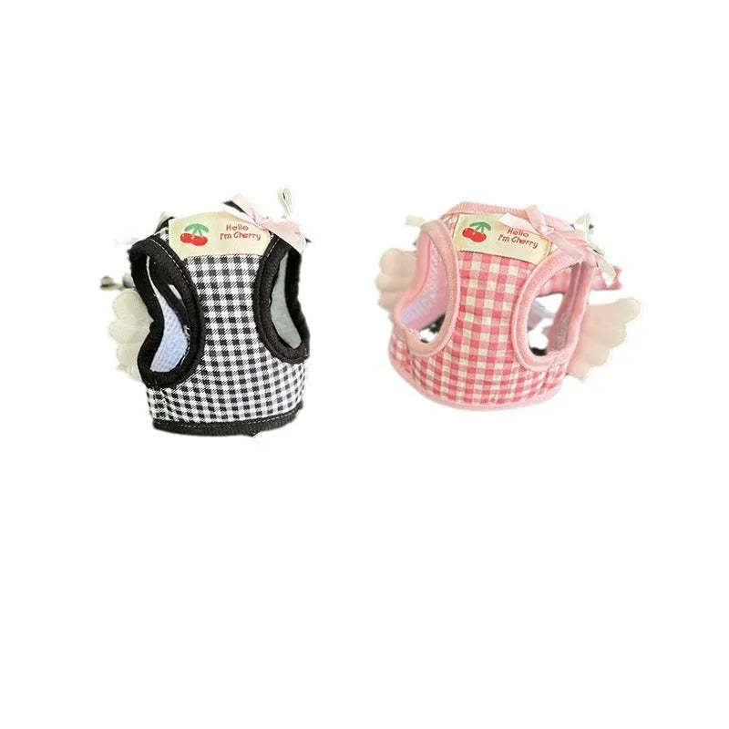 Small dog wearing pink cotton chest and back harness with leash attachment points