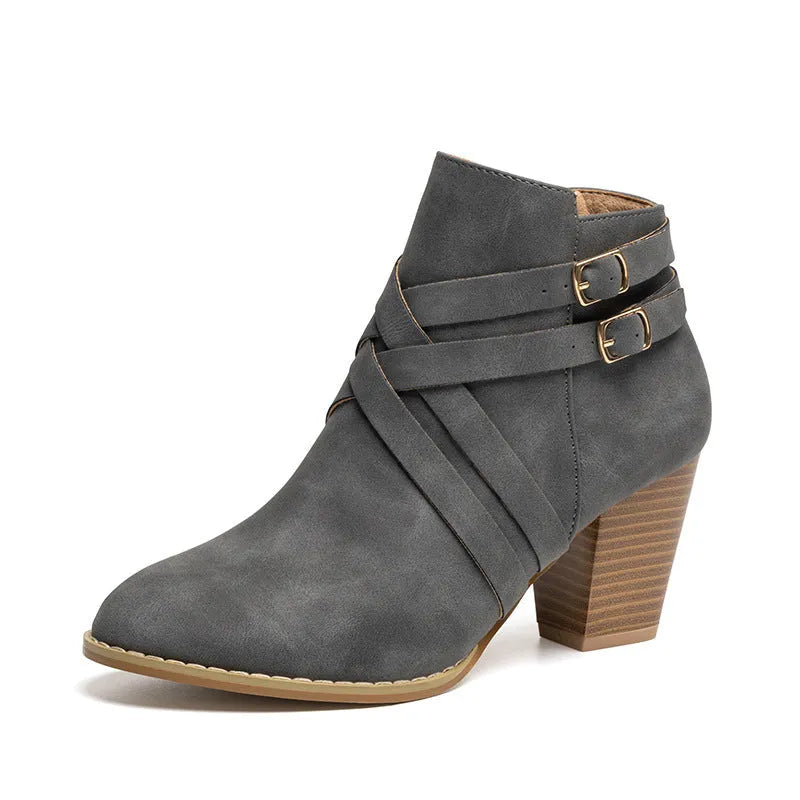 Women's short ankle boot with 7cm heel, side zipper, and belt buckle detail in grey.