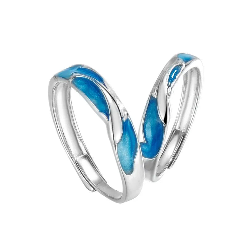 Silver adjustable couple ring with dolphin zodiac motif on white background