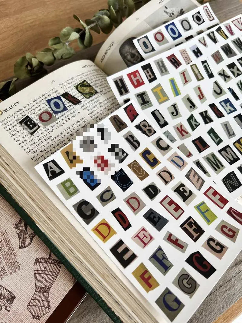A set of cute-style decoration stickers showing printed English letters and weekly words like Monday, Tuesday.