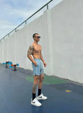 Men's black quick-drying nylon shorts with double-layer ice silk construction on a grey background.