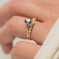 Gold plated women's ring with green zircon stone in flower shape setting, showing front and side views