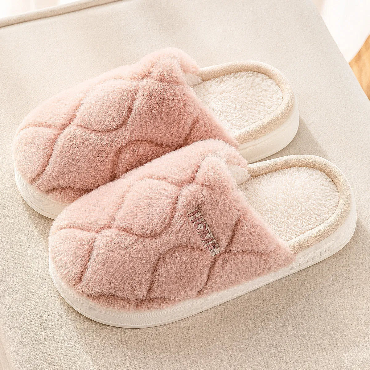 Plush indoor slippers in light gray with car stitching detail on the upper and PVC sole