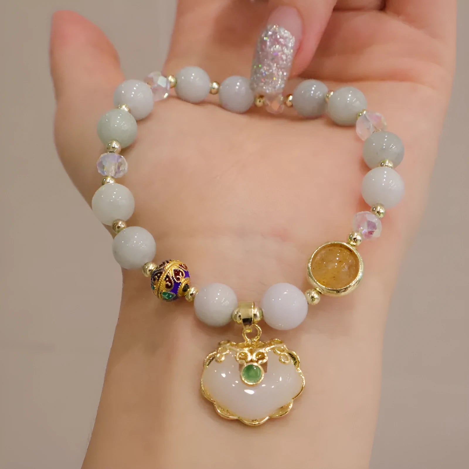 Geometric ethnic bracelet with strawberry quartz stones and metal decoration