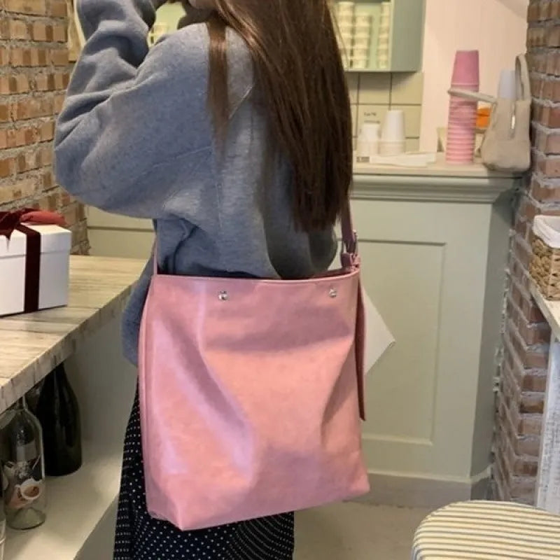 Pink or brown corduroy one-shoulder commuter bag showing dimensions
