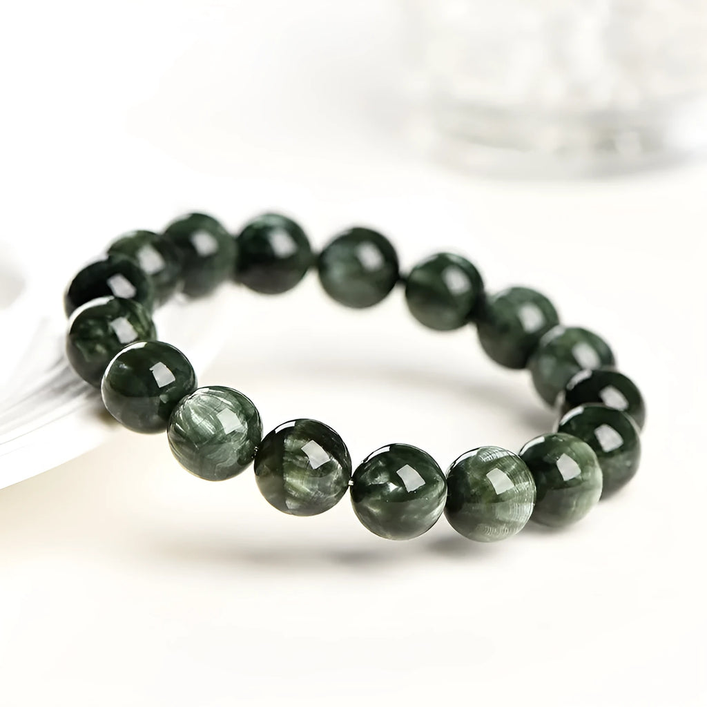 Green Dragon Crystal bracelet with 8-9mm round beads and Ruyi design elements on wrist