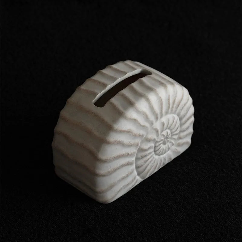 Modern conch shell shaped resin tissue box cover in a conch ramble colour.