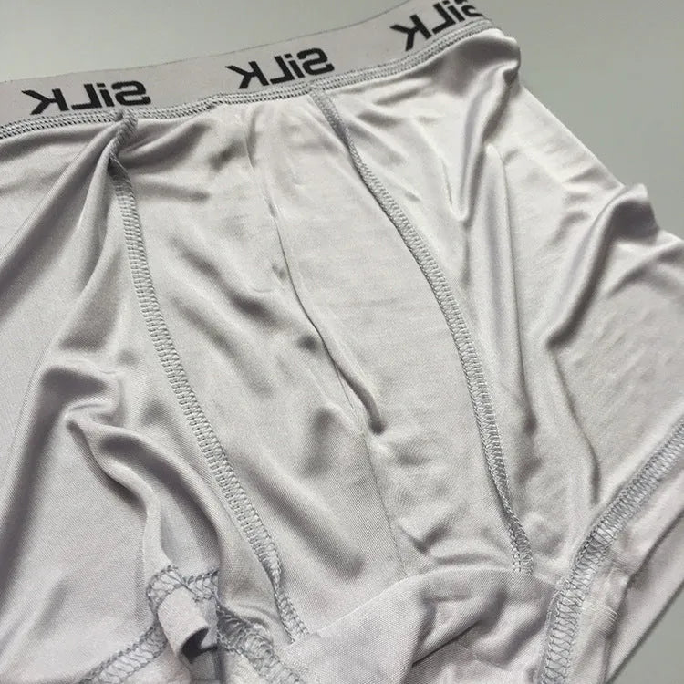 Men's loose-fit silk shorts in navy blue, shown laid flat.