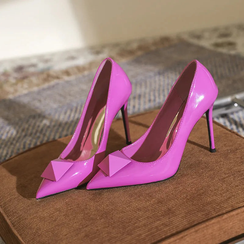 Pink patent leather women's stiletto heels with pointed toe and buckle closure on different heel heights
