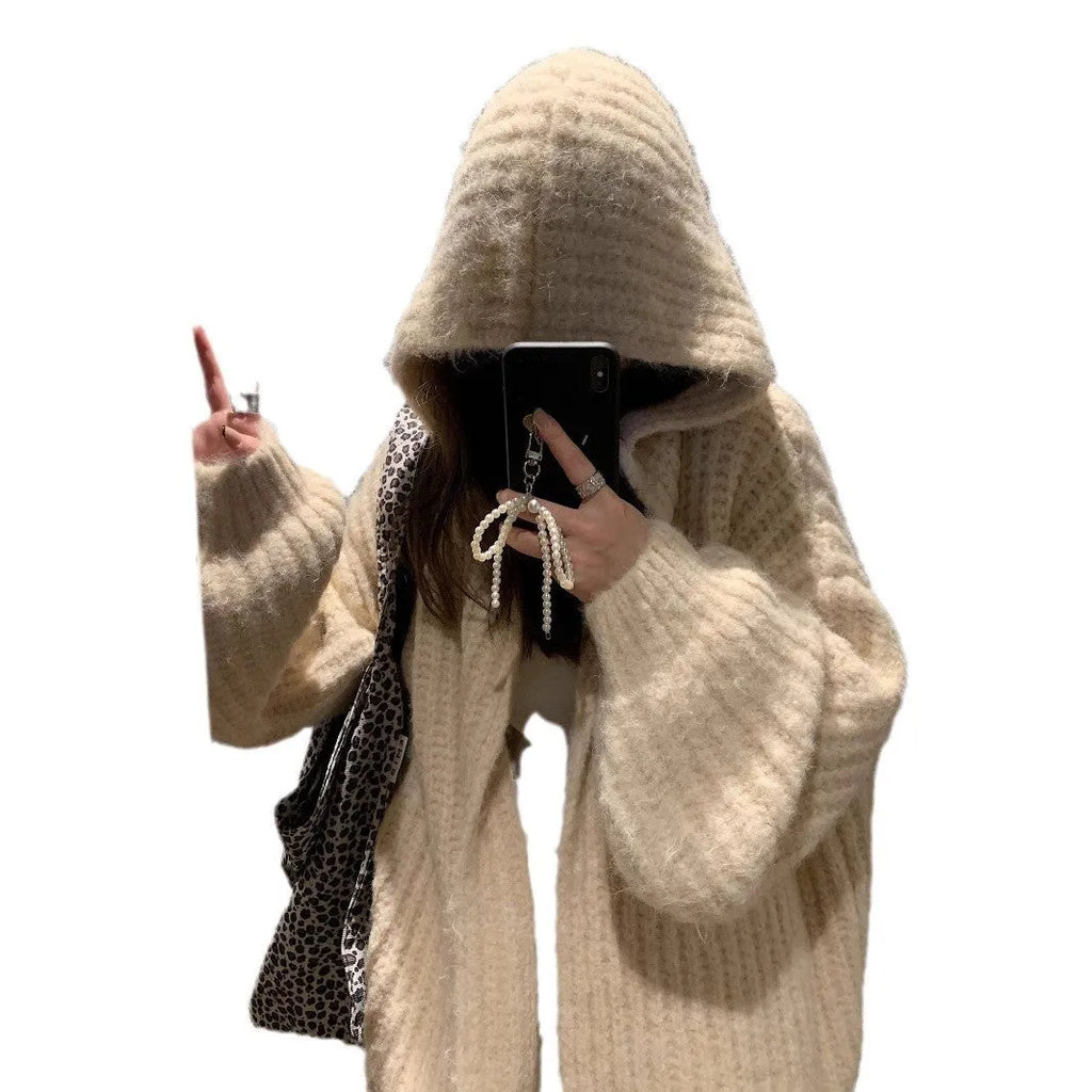 Woman wearing a brown retro-style Maillard hooded cardigan with a thick knit and loose fit.