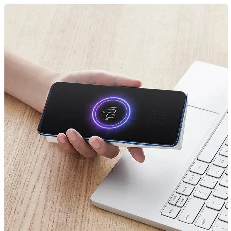 White and black large capacity 10000mAh power bank with USB Type-C port and wireless charging pad.