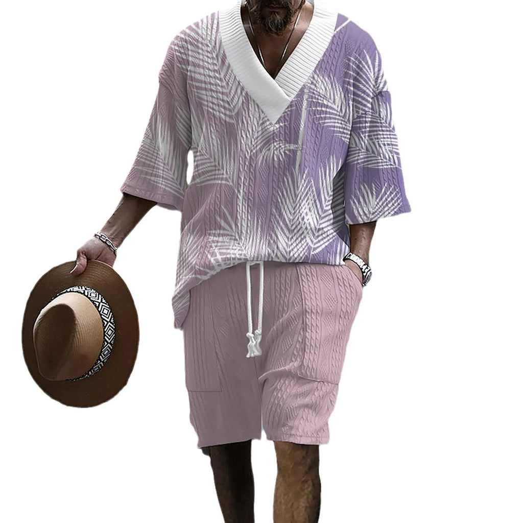 Man wearing a printed drop-shoulder knitted top and matching shorts from a two-piece lounge suit.