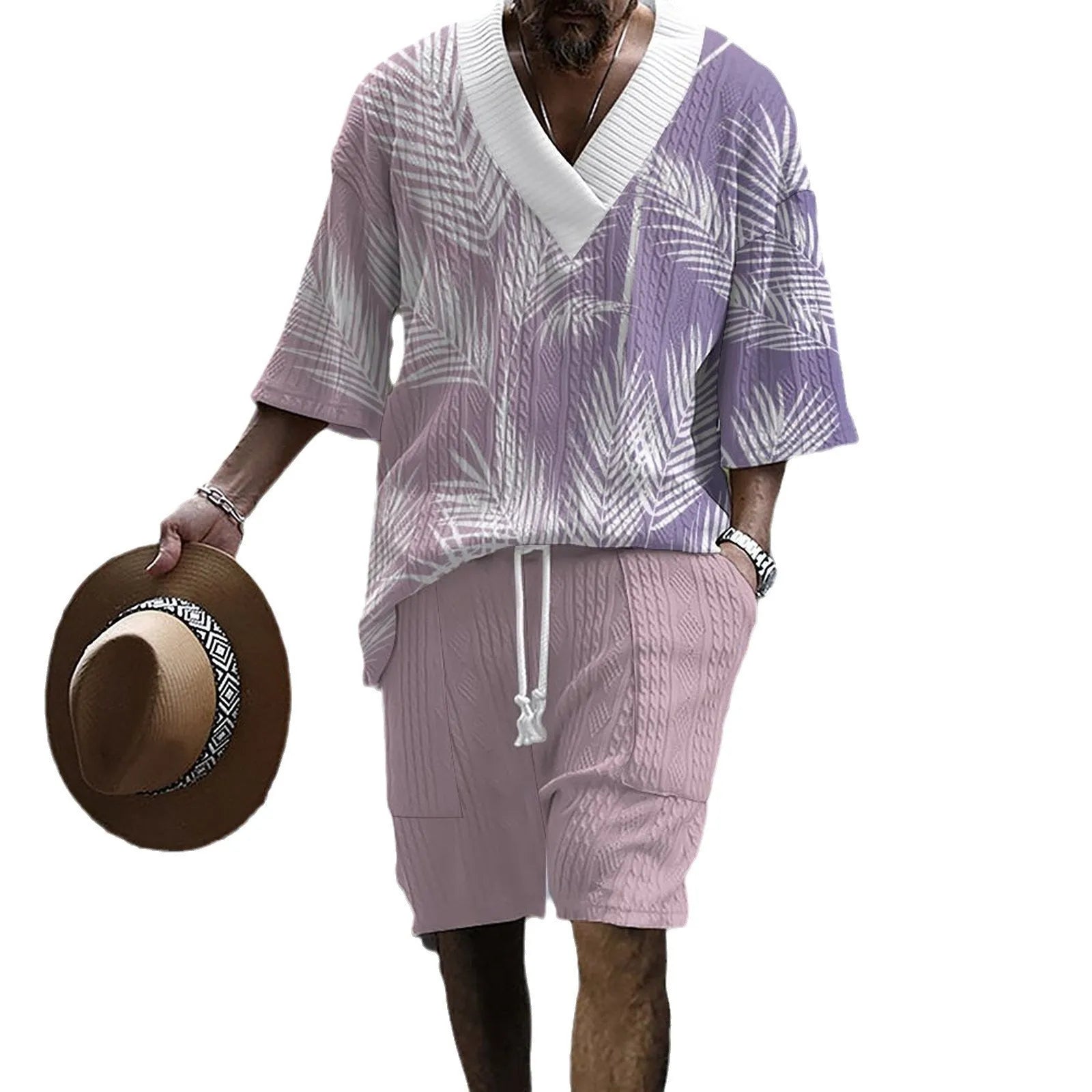 Man wearing a printed drop-shoulder knitted top and matching shorts from a two-piece lounge suit.