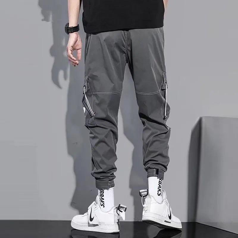 Men's loose fit solid colour polyester trousers in gray, front view, for casual autumn wear