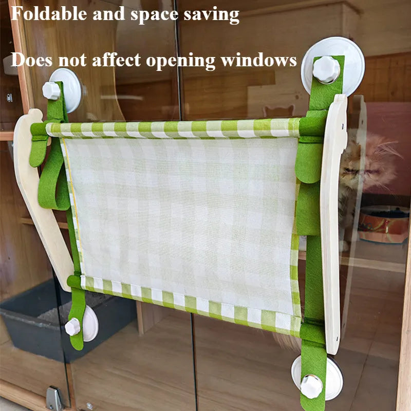 Wooden cat window hammock with suction cups on a glass window