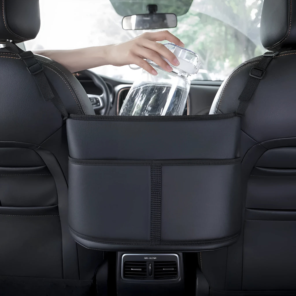Genuine leather car seat storage bag with carbon fibre pattern, shown installed in a middle seat net pocket.