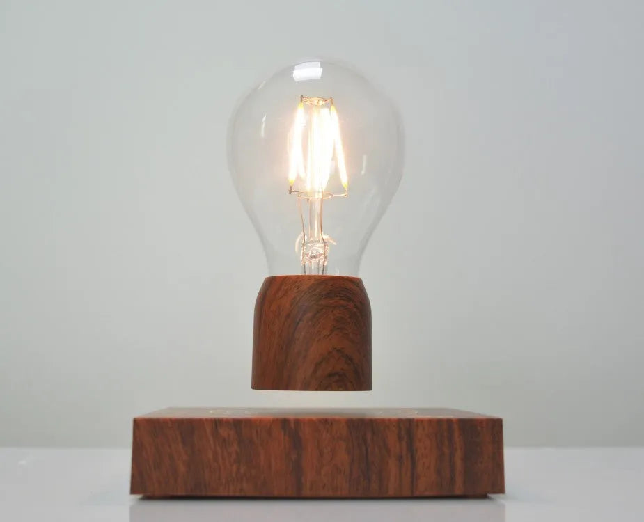Magnetic levitation floating light bulb on imitation wood base with choice of international plugs.