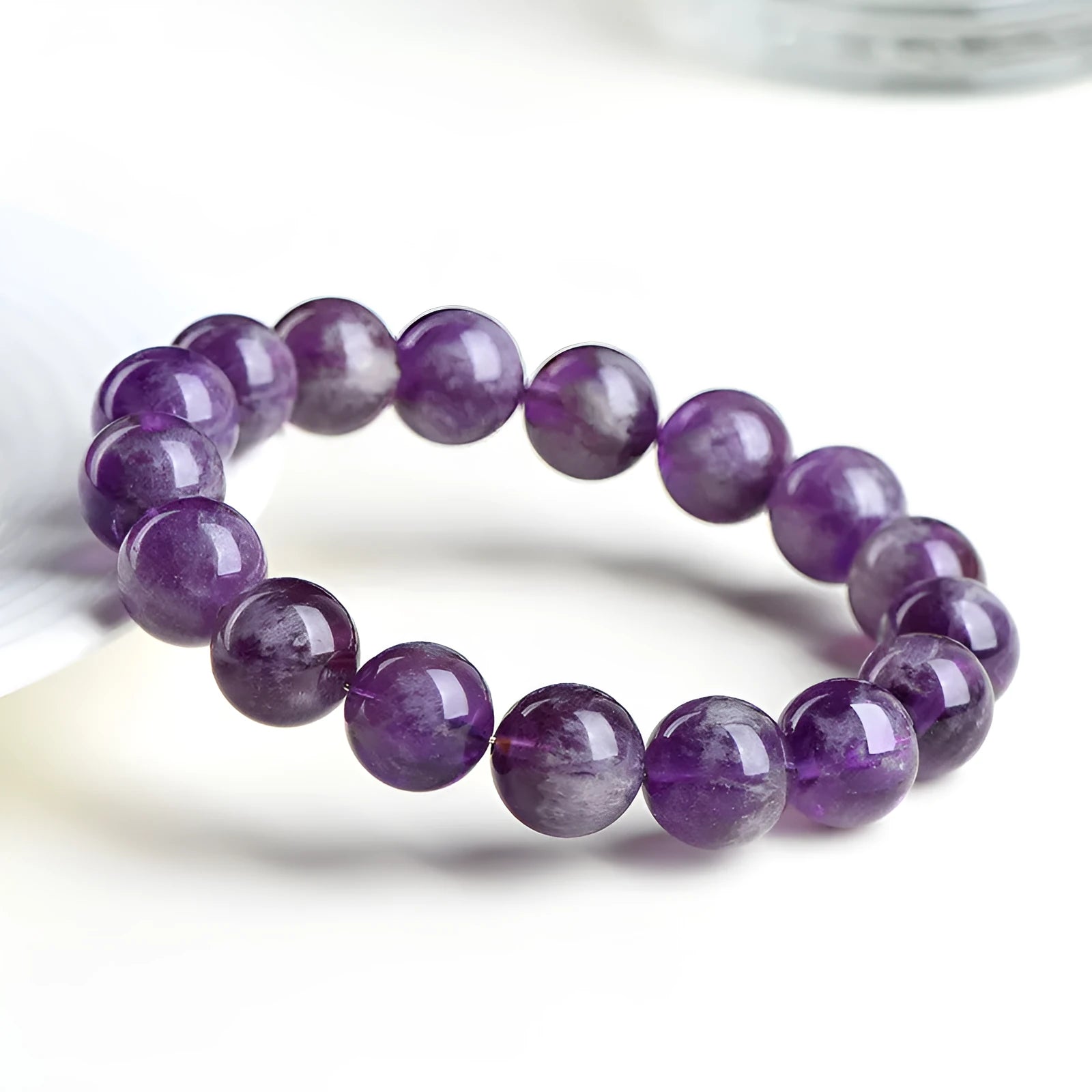 Natural feather amethyst crystal bracelet in snow mountain purple with scattered beads and ruyi geometry.