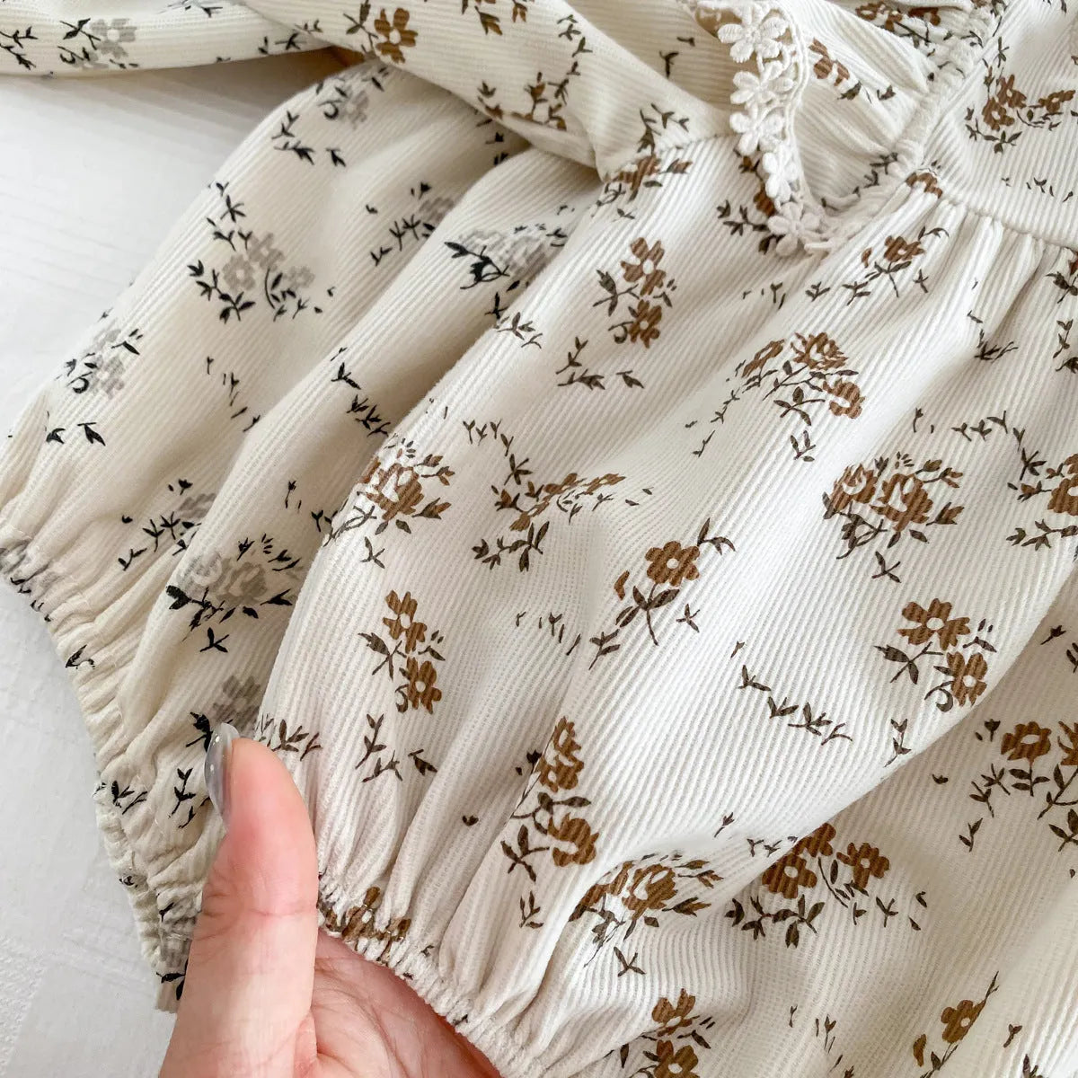 Baby girl corduroy floral jumpsuit in triangle style with long sleeves, round neck, available in black shivering colour