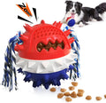 Blue and red squeaky dog chew toy with treat dispenser hole, shown next to a dog.