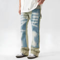 Retro jeans featuring yellow and blue patchwork splash-ink damaged design on non-stretch denim.