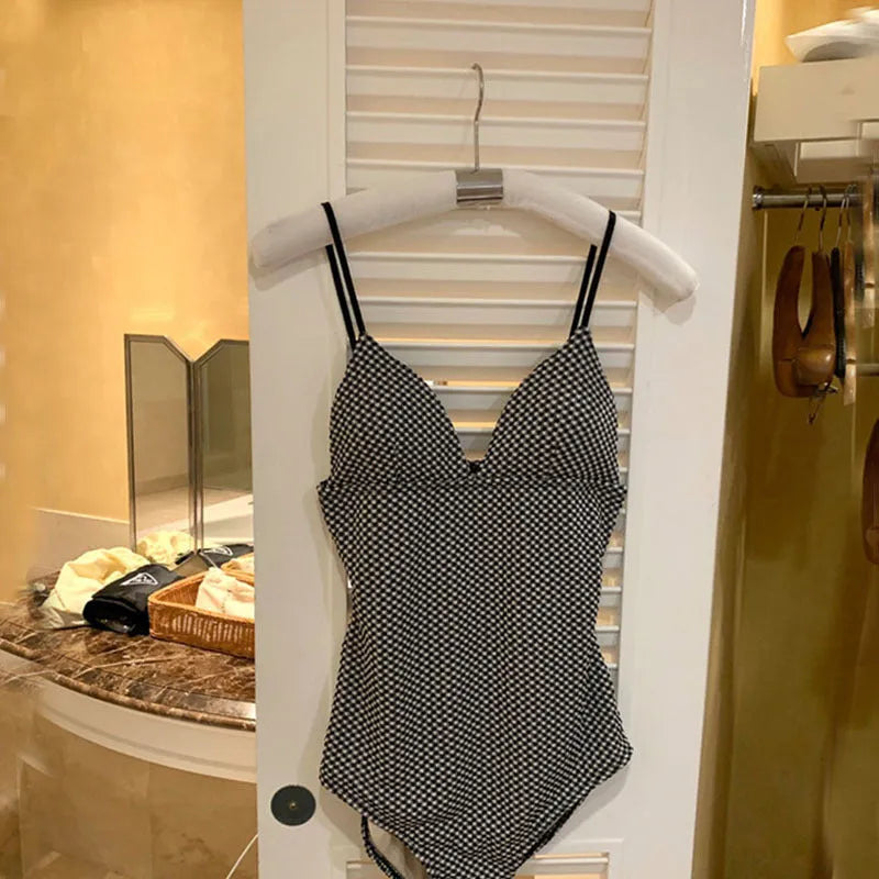 Blue one-piece swimsuit for hot spring use with belly coverage and smaller chest design
