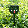 Green solar-powered ultrasonic animal repeller with LED strobe lights for outdoor dog and pest control