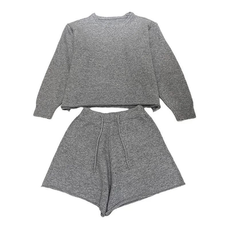 Women's loose-fitting knitted two-piece set showing long sleeve sweater and wide leg shorts in oatmeal colour