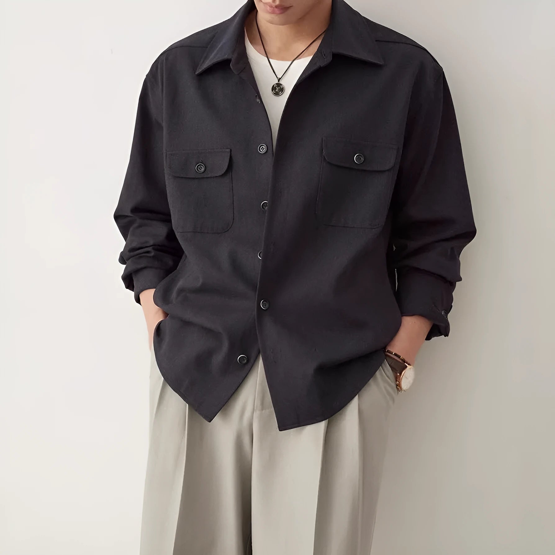 Men's light sand rice coloured long sleeve shirt with a simple lapel, laid flat.