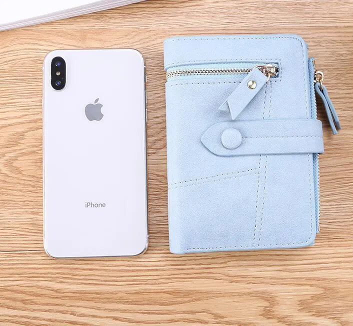 Vegan woman faux leather short wallet with zipper closure in solid colour, showing interior with bill and card compartments