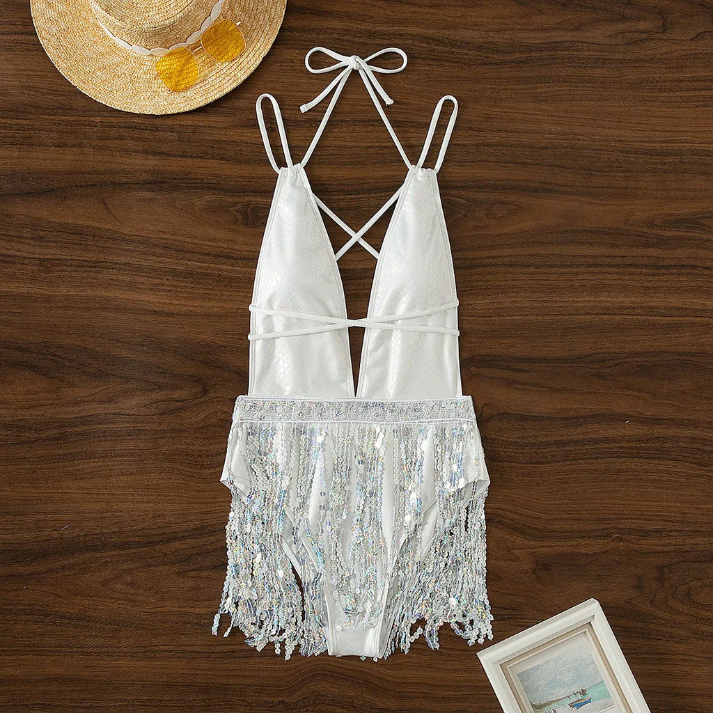 White women's one-piece swimsuit with deep V-neck, tassel hem detailing, and briefs-style bottom