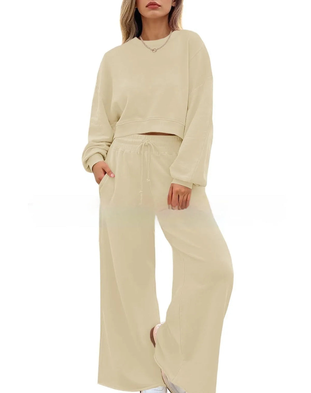 Women's solid colour casual trouser set with long sleeves in pink, showing top and trousers laid flat.
