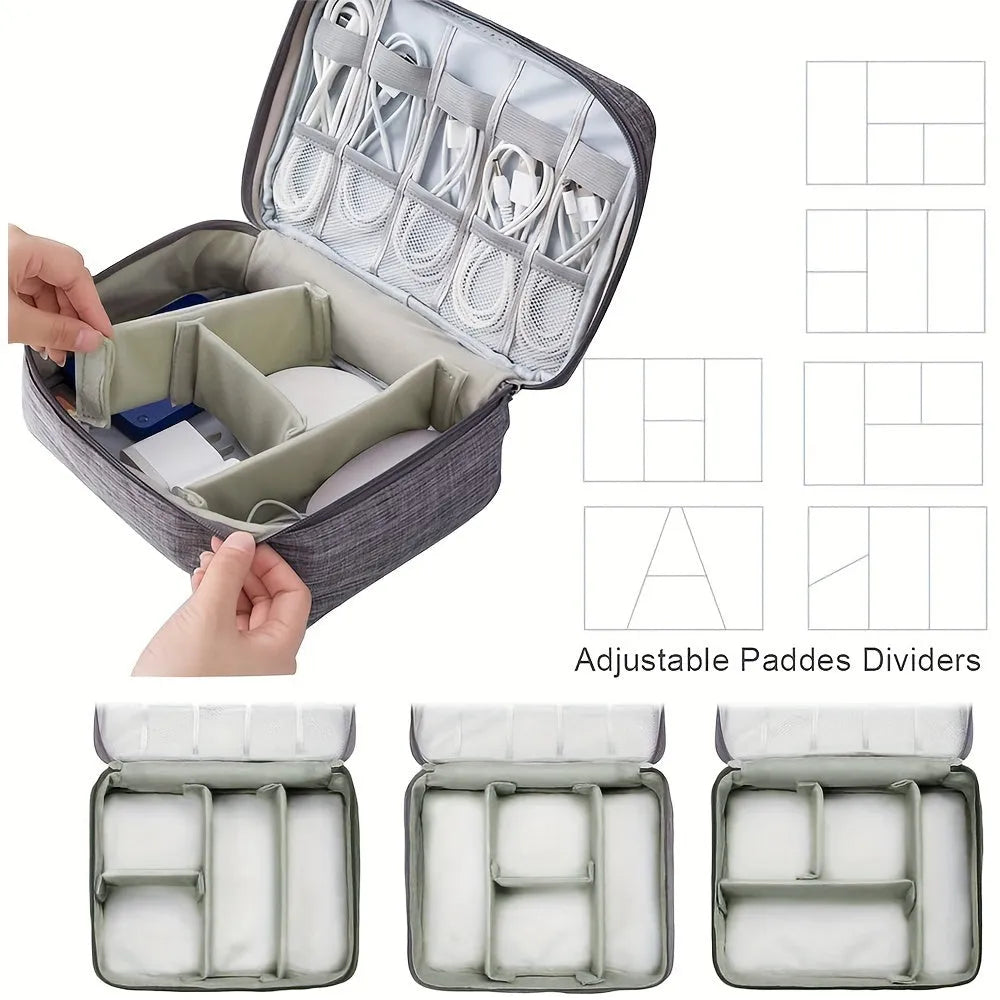 Black waterproof electronics travel organizer case open, showing mesh pockets, elastic loops and removable padded dividers.