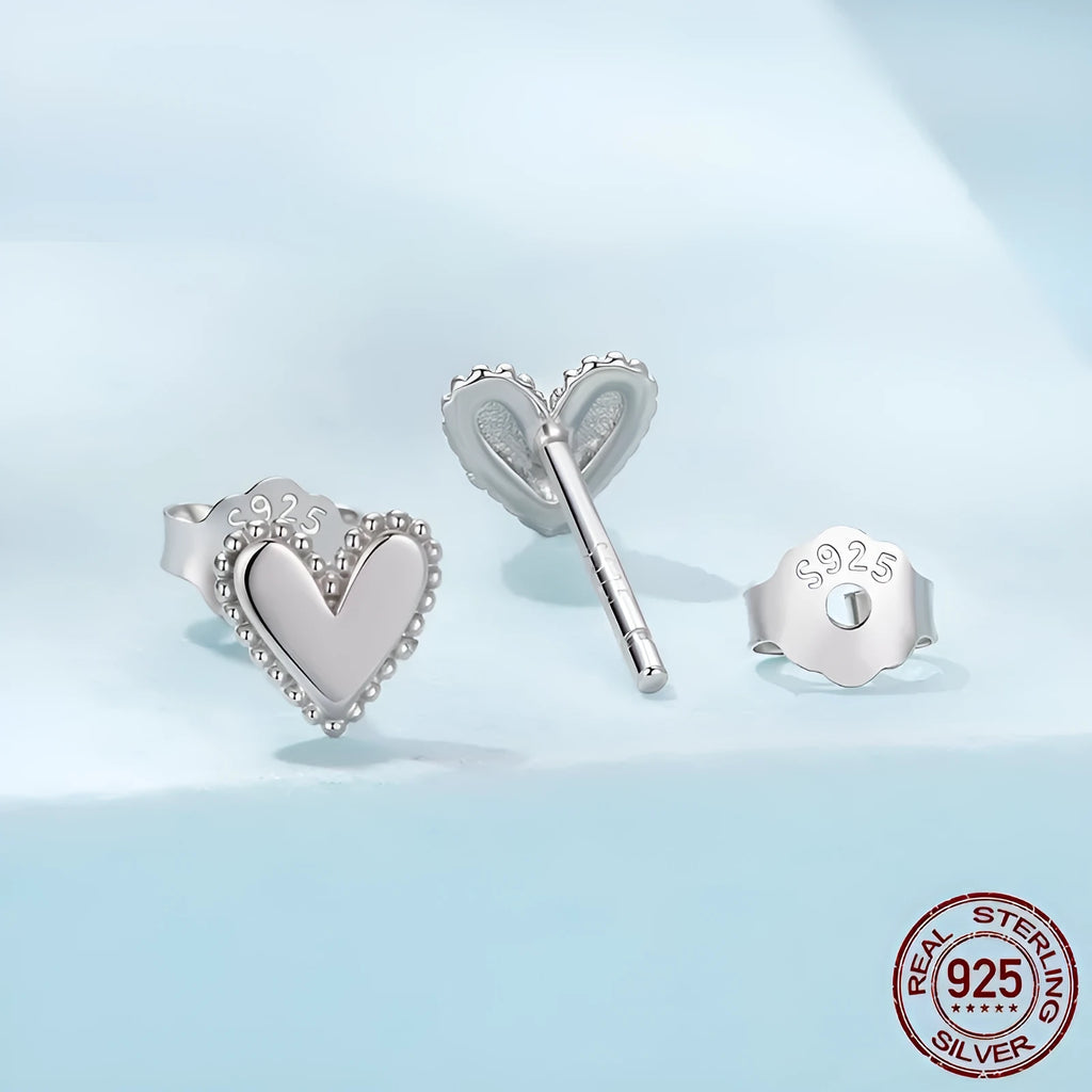 Simple S925 sterling silver heart-shaped ear studs with electroplated finish on a white background