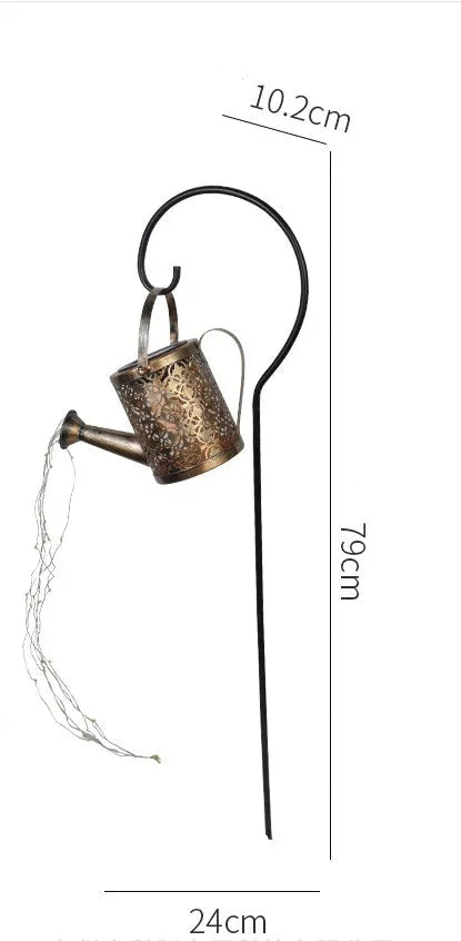 Solar watering can garden lamp with hollow-out iron shower body and 36 warm white LED lights on copper wire, installed in grass