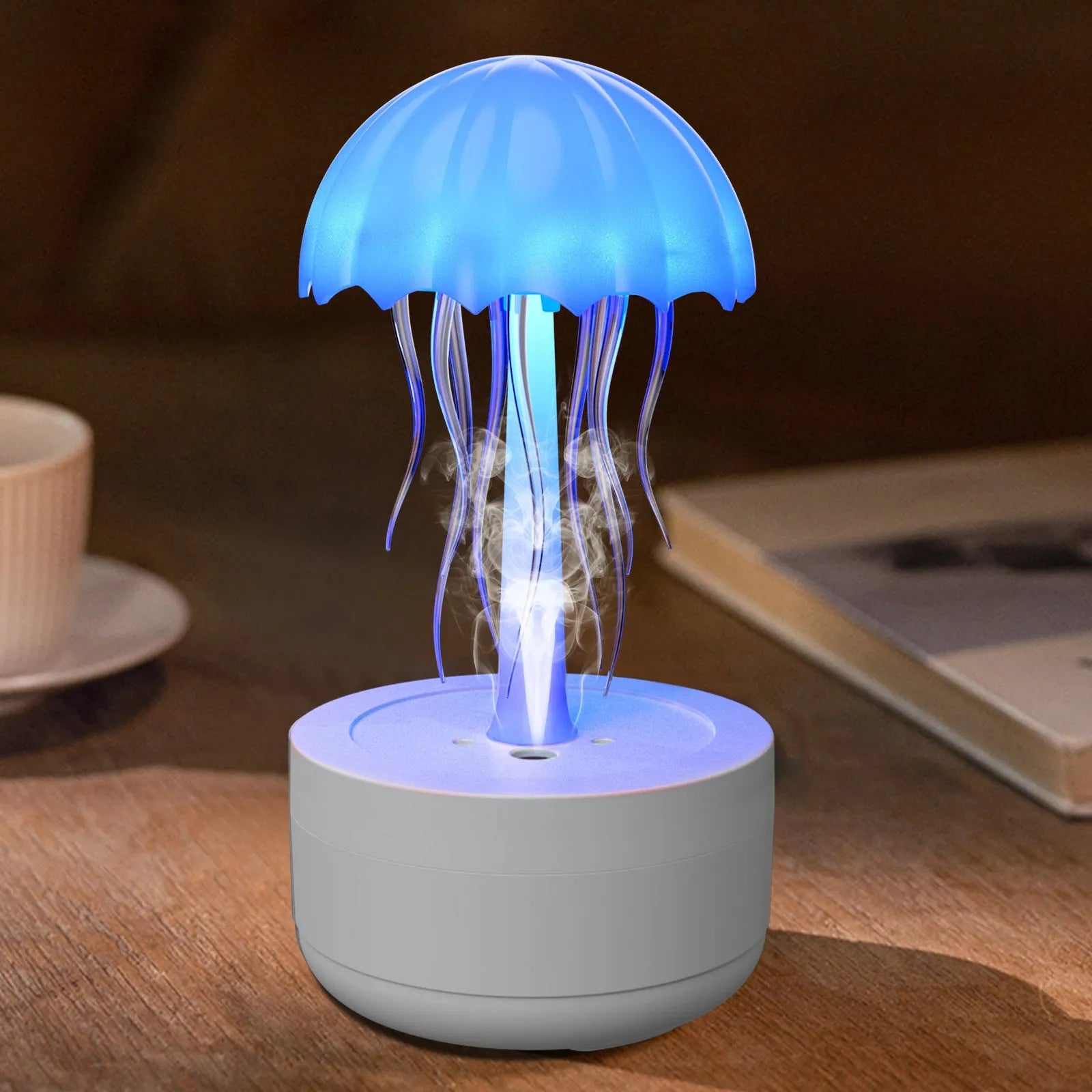 White jellyfish-shaped humidifier and essential oil diffuser with colourful LED night light on desktop