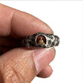 Hand-forged copper Grotto Buddha ring with rock texture on a size 8 band.