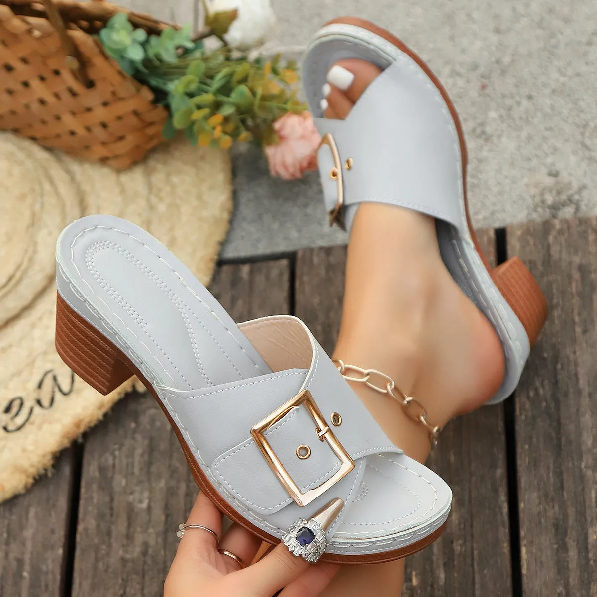 Women's black summer slippers with a chunky heel, round toe, and a silver metal buckle fastening.
