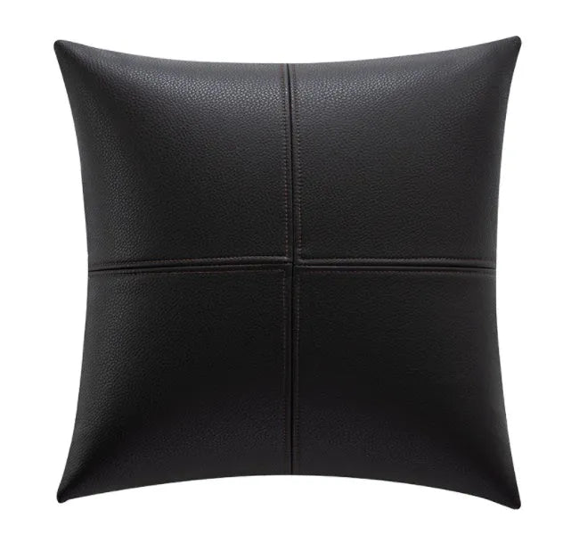 A solid colour soft cowhide leather pillow cover on a sofa, shown in a neutral tone.