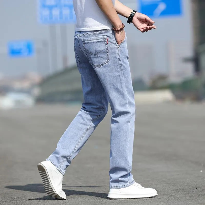 Man wearing smoky grey straight leg jeans with low waist and zipper fly.