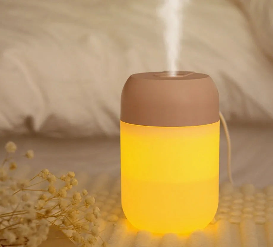 Small white cylindrical USB humidifier with aromatherapy function for desk use