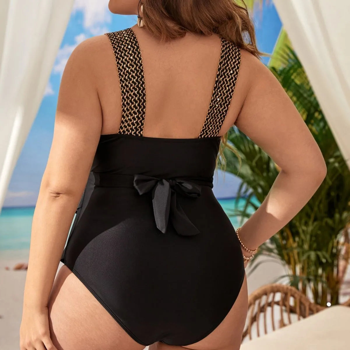Plus-size black one-piece swimsuit with chest pad on a mannequin.