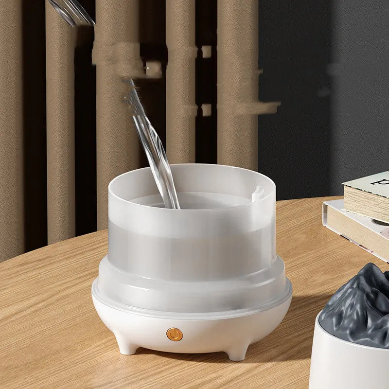 White Huoyanshan volcanic-shaped ultrasonic humidifier and aromatherapy diffuser on a table.