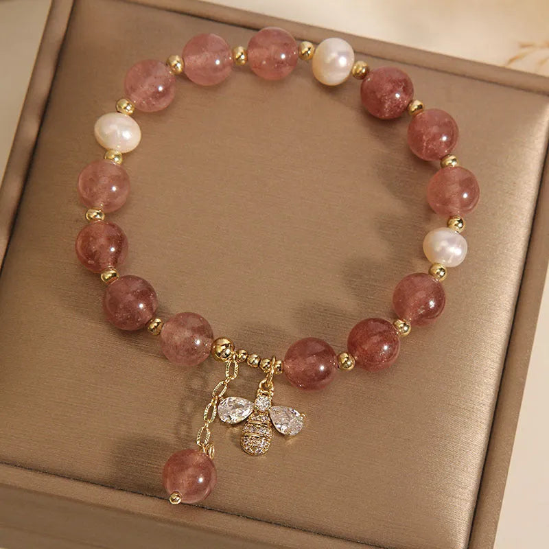 Women's bracelet with strawberry quartz stones, freshwater pearls, and zircon accents on an alloy chain.
