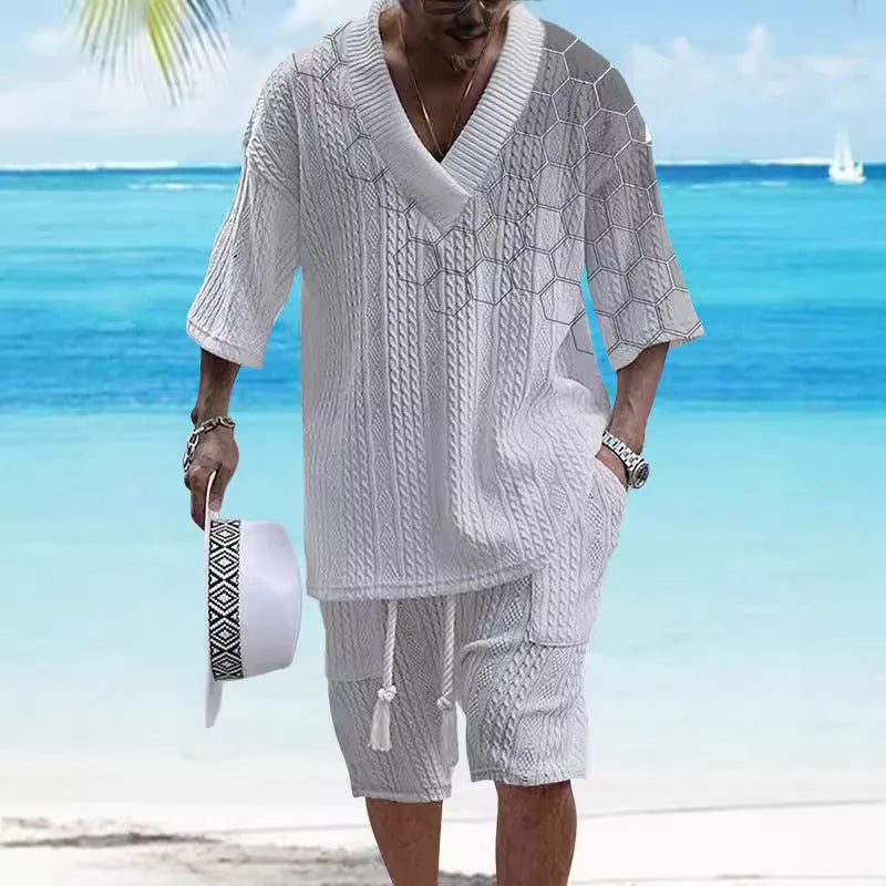 Man wearing a printed drop-shoulder knitted top and matching shorts from a two-piece lounge suit.