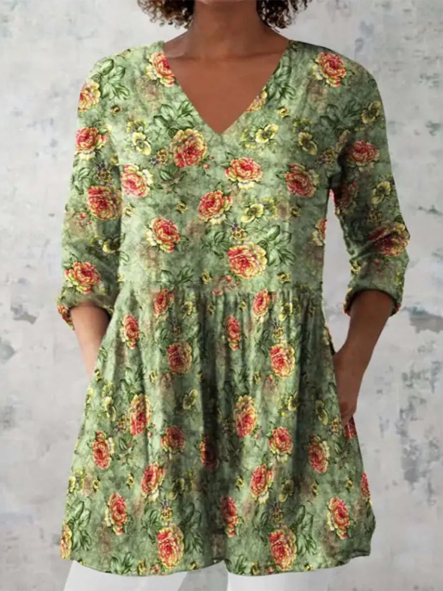 A woman wearing a loose, printed dress with 3/4 sleeves and a wide waist, available in multiple sizes.