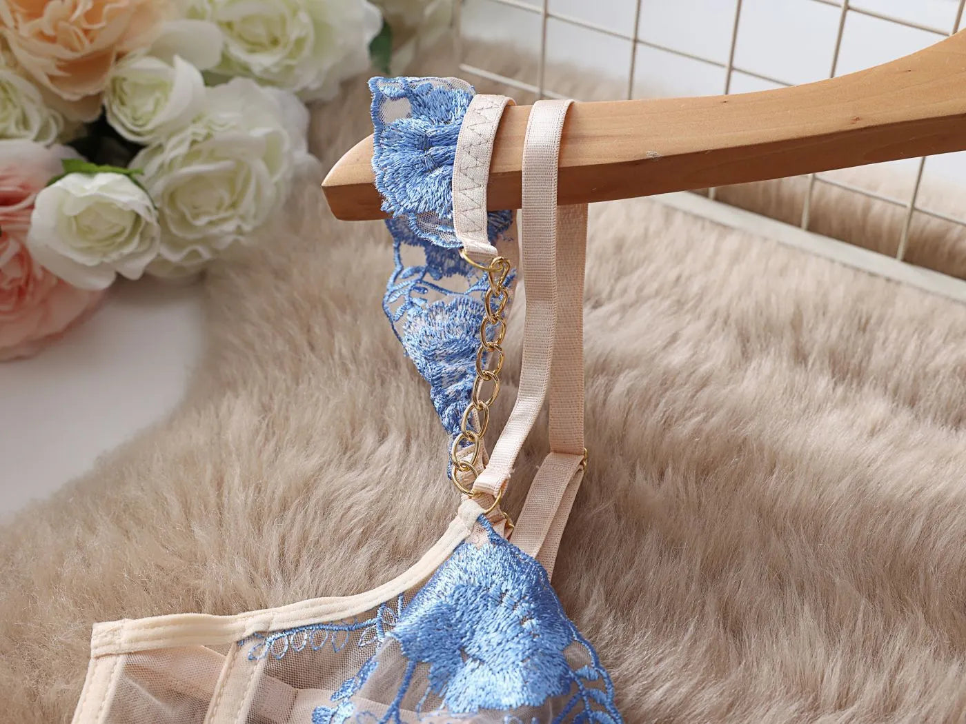 Light blue embroidered lace women's bra and panty set with transparent push up design and mesh detail.