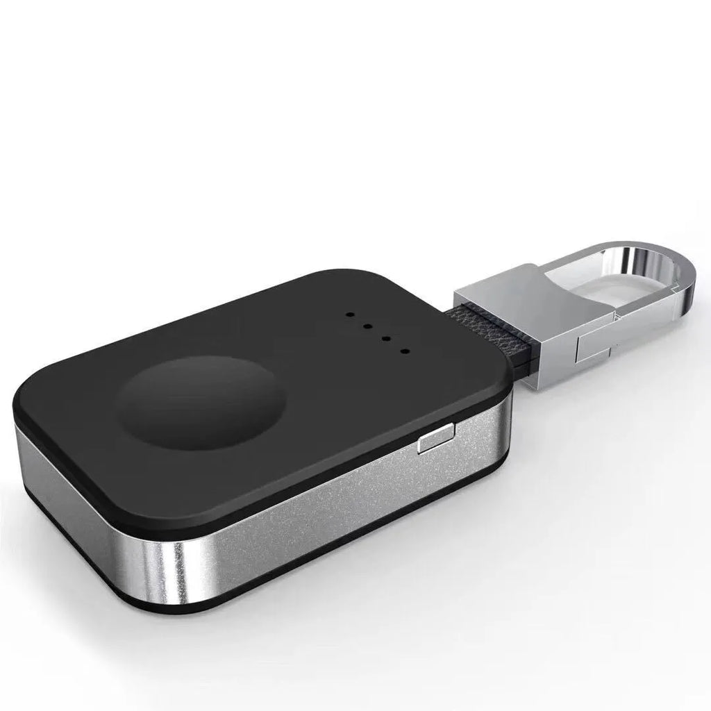 Black Apple Watch portable wireless charger keychain with keyring, shown next to an Apple Watch.